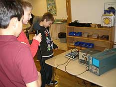 Students measure sound waves with scientific equipment